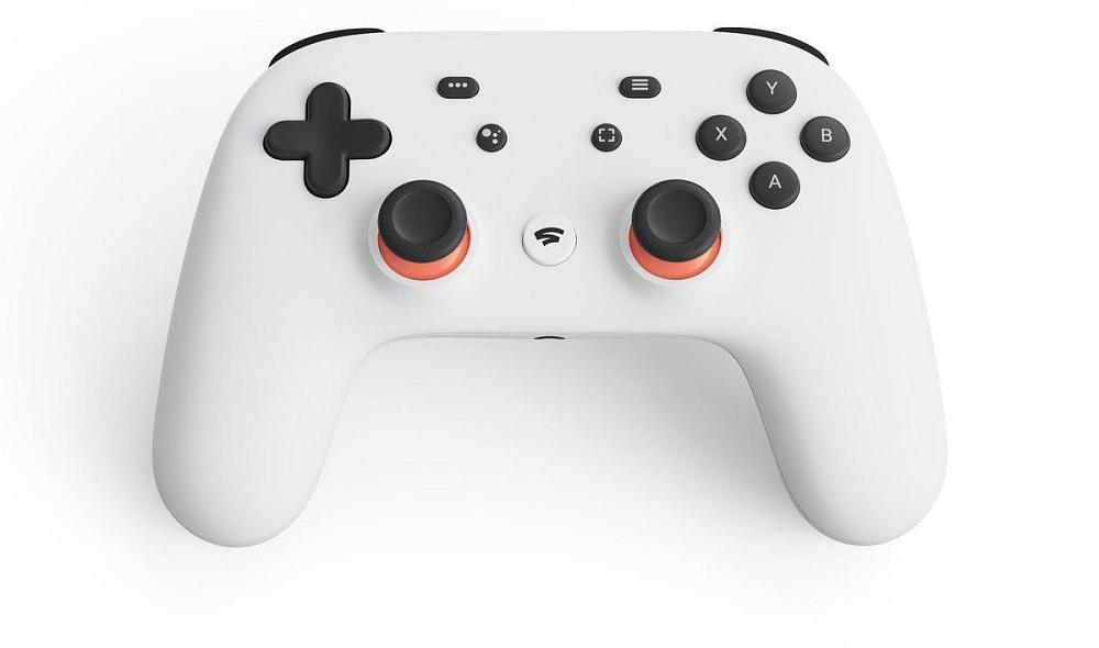 Photo of a game controller. The controller is white with black face buttons. There is a hint of orange on the two sticks.
