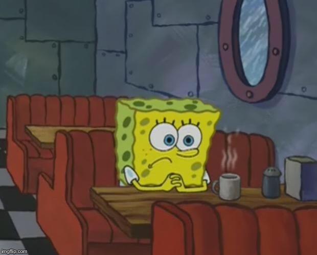 A yellow sentient sponge sitting at a diner table staring at a cup of coffee on his table.