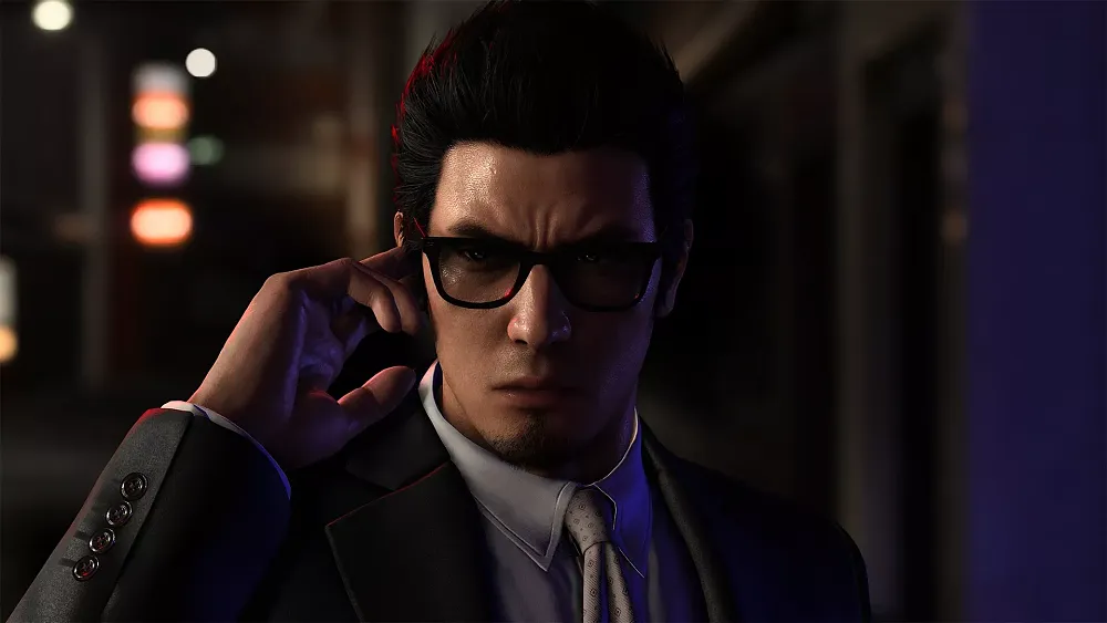 A man in shades and a suit glaring at the viewer.