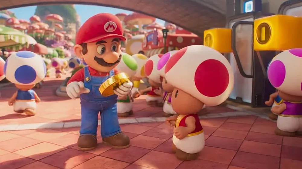 Mario holding a big gold coin and looking at Toad in a scene from The Super Mario Bros. Movie.