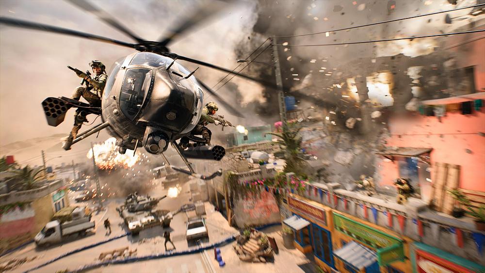 A helicopter flies through a desert town in the midst of a war.