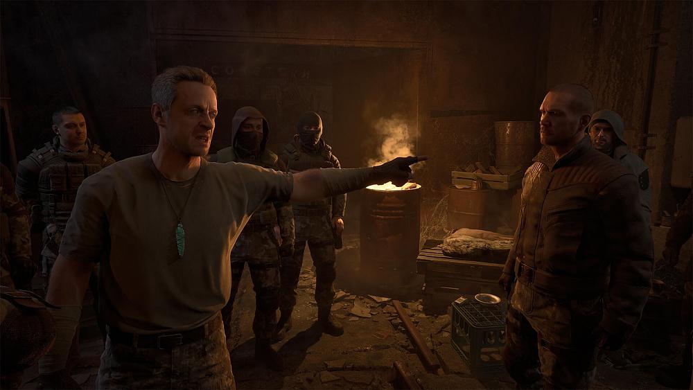 A man angrily pointing at another man while a small group surrounds the two in the background. A barrel with a burning fire is also seen in the background.