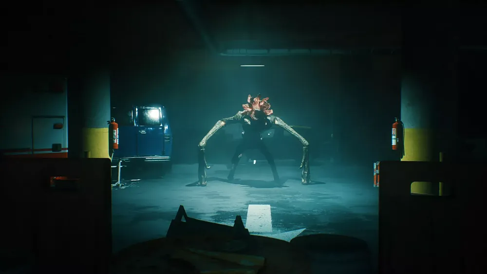 An alien walking on its front arm-legs standing under a light inside a dark parking garage.