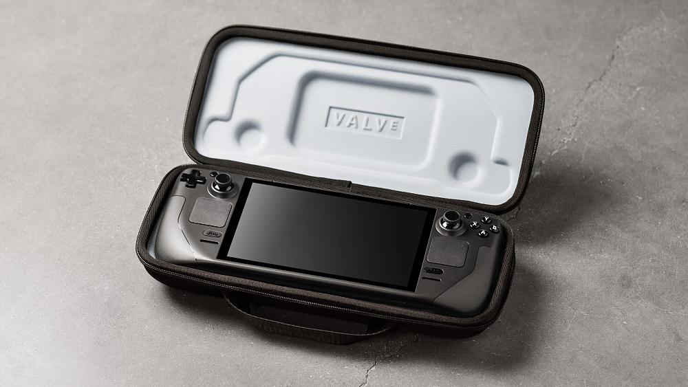 A portable PC gaming device sitting inside an open carrying case.