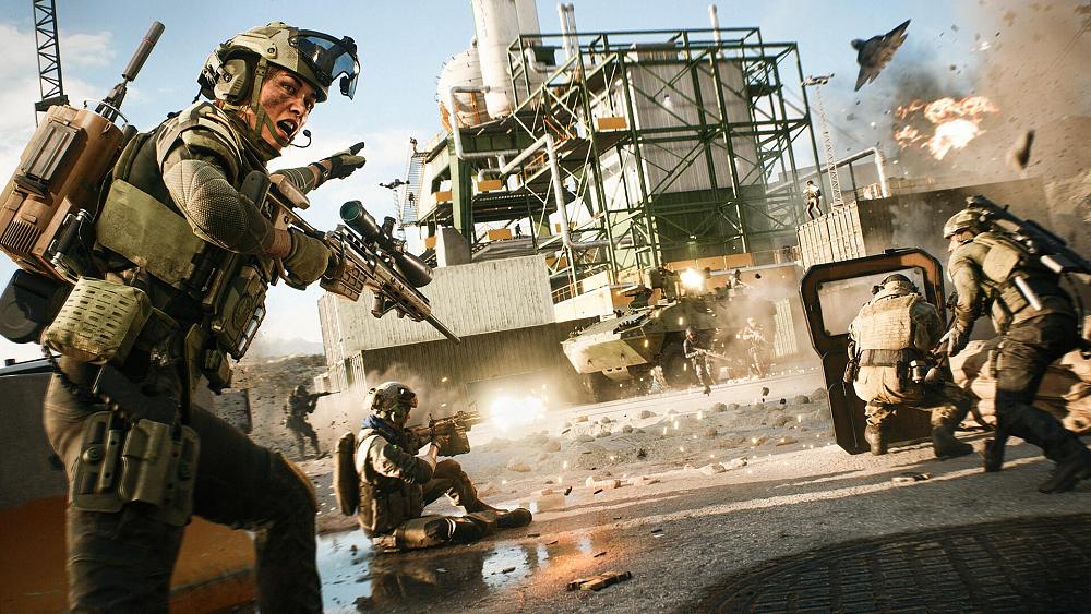 Soldiers yelling and engaging in a warzone set near some sort of mining area or industrial plant.