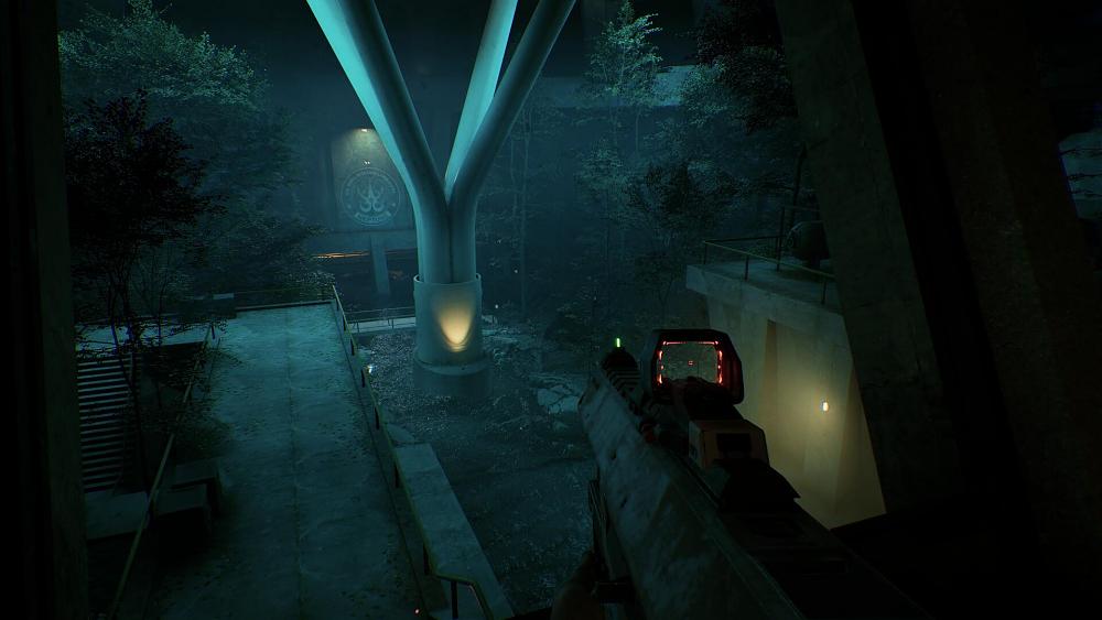 A dark scene set under the sea in a facility. The view is from someone holding some sort of assault rifle.
