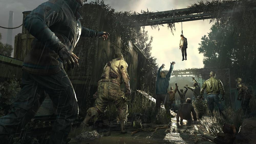 A group of zombies walking around an abandoned train yard in the rain.
