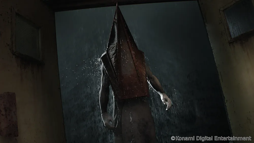 A person wearing a giant metallic pyramid covering over their head. They are standing in a doorway as rain pours down outside behind them.