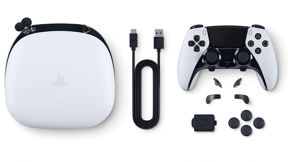 Photo showing a PlayStation 5 premium controller. Separate components such as buttons and paddles are shown laying below the controller. A braided USB cable is seen in the middle of the photo. A white carrying case for the controller is seen on the left side of the image.