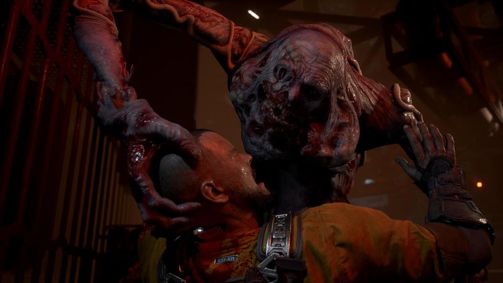 A grotesque, deformed, tall mutant creature attacks a man. The man is bald, wearing an orange prison jumpsuit, and screaming in pain.