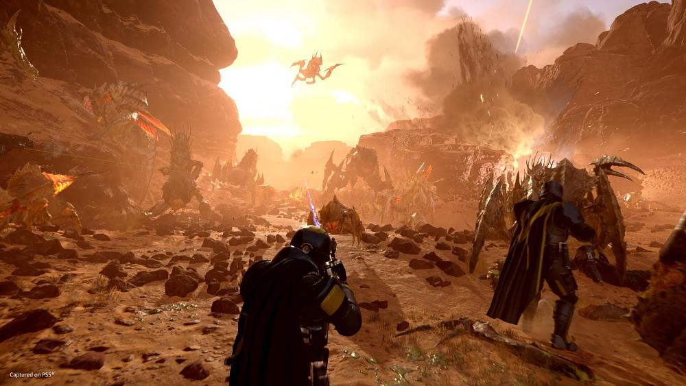 Soldiers fighting off giant alien bugs.