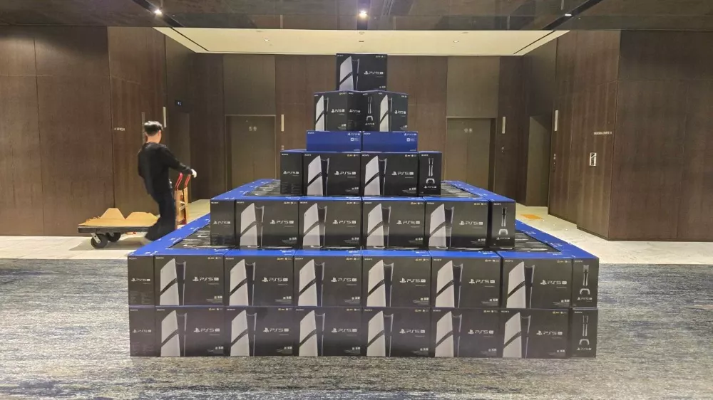 A mountain of PlayStation 5 Pro consoles sitting in a room.