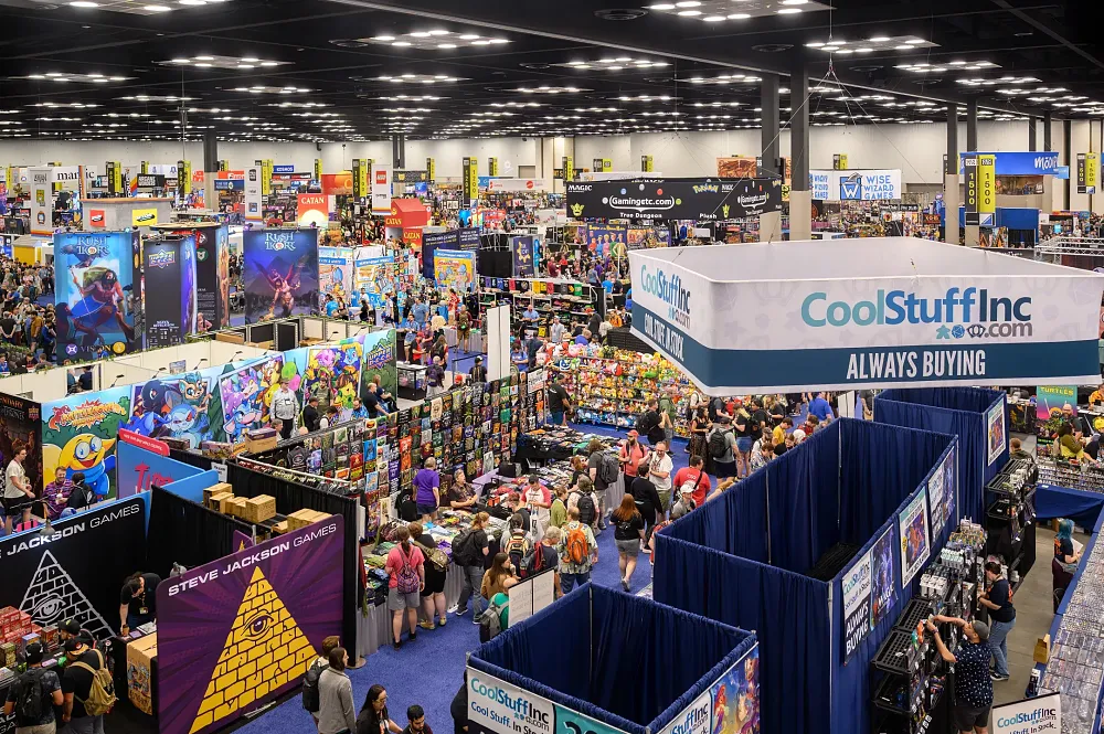 A photograph of the show floor at Gen Con 2025 showing a ton of tabletop booths and tons of people.
