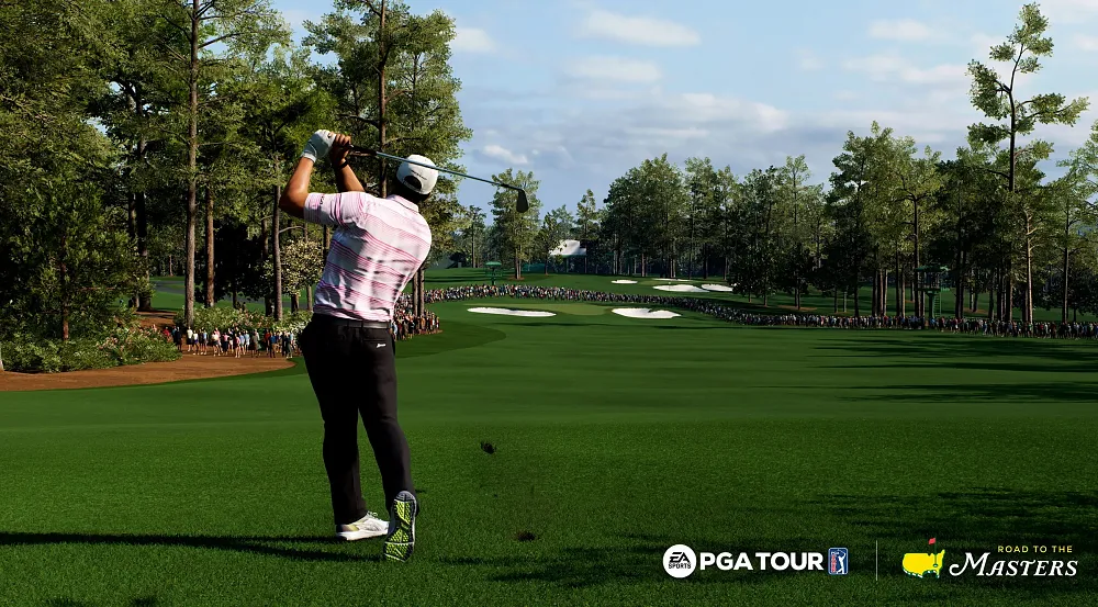 A golfer at the end of their swing on a beautiful lush golf course. They are watching their golf ball fly through the air.