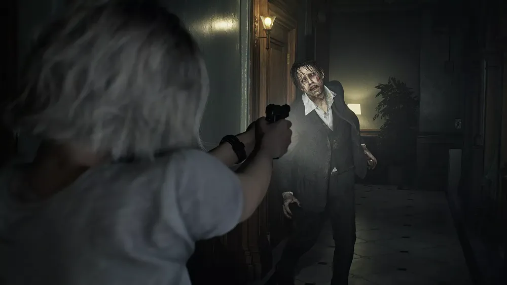 Resident Evil Requiem screenshot showing Grace Ashcroft aiming a pistol at an approaching zombie.
