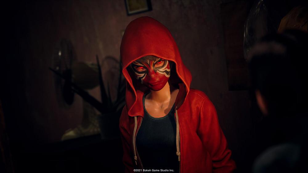 A woman in a red hoodie with a red mask covering her entire face.
