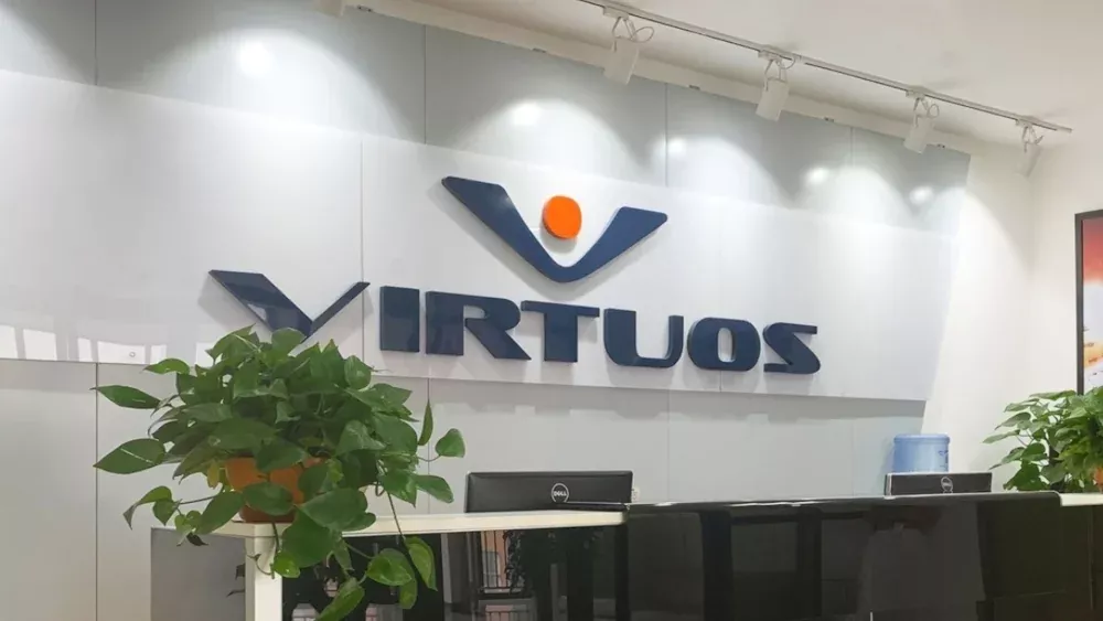 The logo for Virtuos on a wall in a new office building.