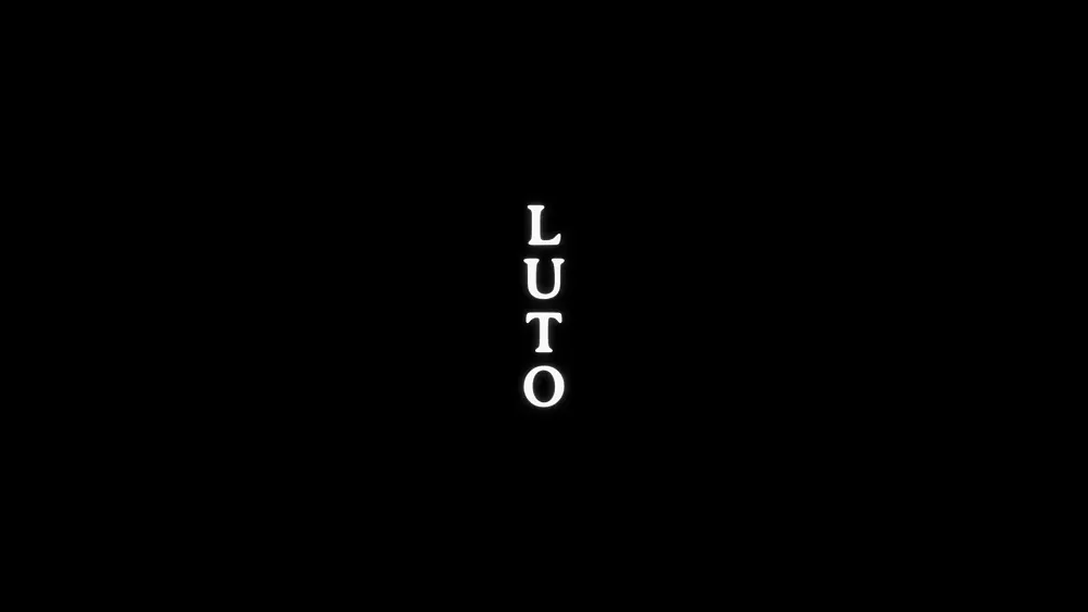 Vertical white text on a black background, that says LUTO