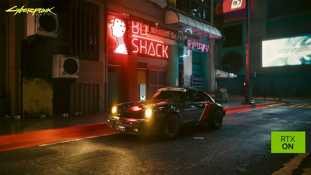 A game screenshot showing a chrome car sitting on a street at night with several storefront neon signs lighting the area.