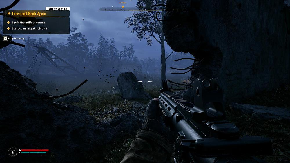 Screenshot from the game showing a first-person view of someone holding a modern looking assault rifle and approaching a break in a cement wall at night.