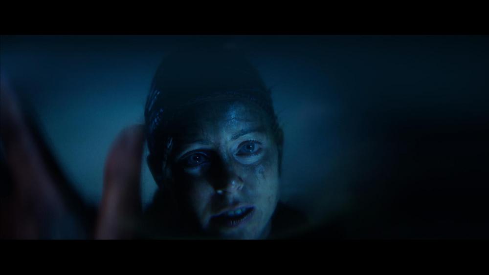 A closeup of the face of a hyper realistic looking human, Senua, from the game Senua's Saga: Hellblade 2.