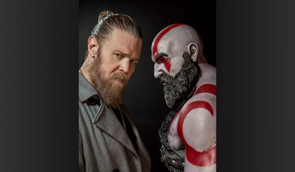 Actor Ryan Hurst, hired to portray a live-action Kratos, next to a digital version of Kratos from the 2018 and newer God of War games.