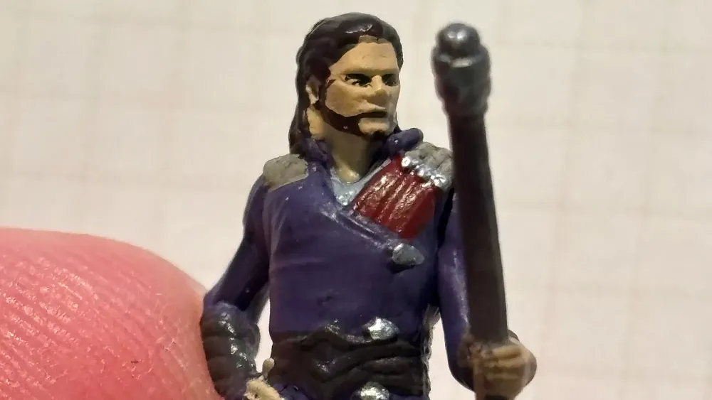 A closeup of a terrible, like REALLY BAD, painted mini for Baldur's Gate 3.