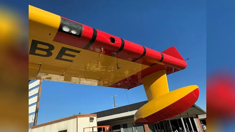 A photo of a 3 inch by 6 inch hole in the left wing of a Super Scooper firefighting plane after being hit by a drone.