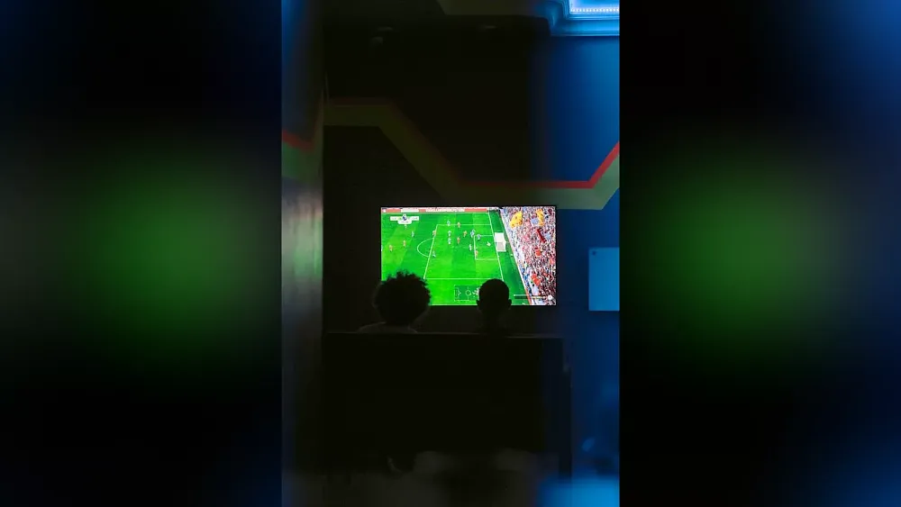 Image of people watching or playing a game of FIFA soccer. Image is from Unsplash.com.