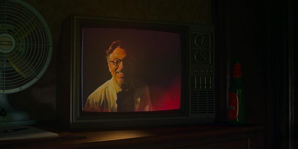 A scientist smiling on a TV.