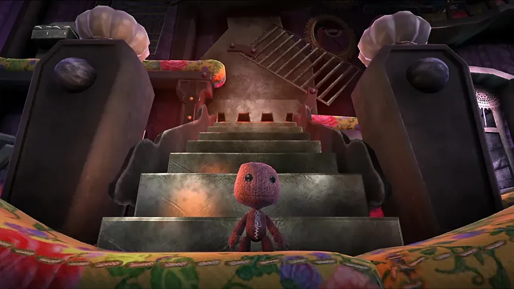 Screenshot of LittleBigPlanet 3 showing Sackboy standing in front of some stairs.