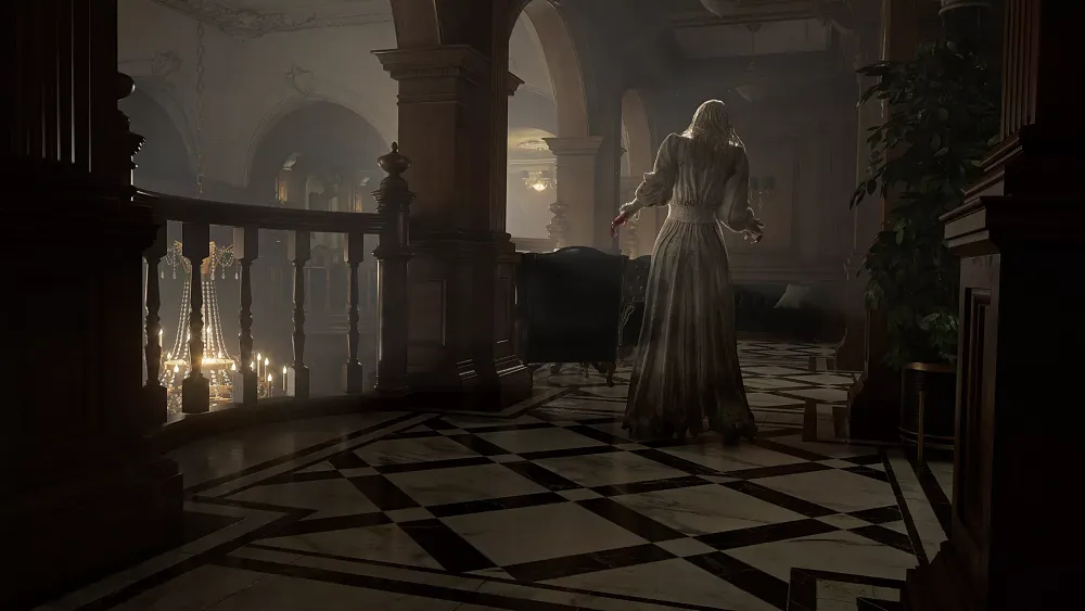 A woman in a dirty white gown walking down a balcony hallway away from the camera.