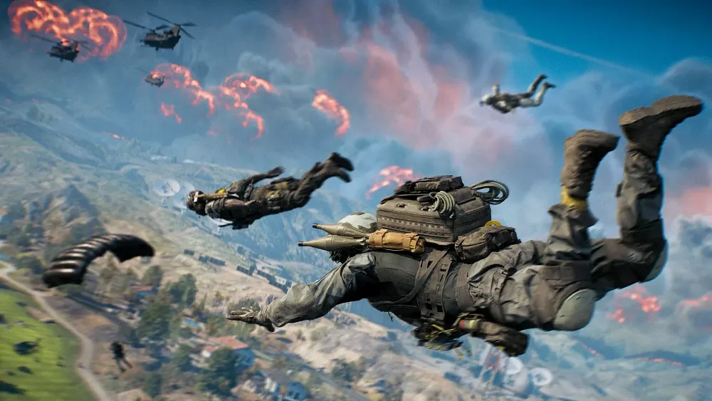 Troopers parachuting from helicopters down to a battlefield.