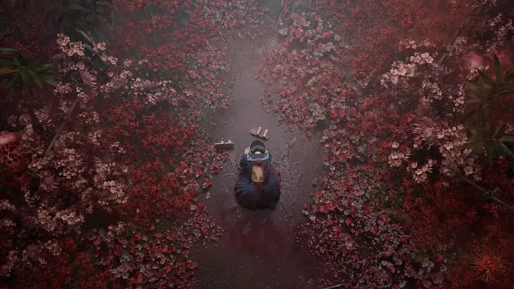 A young woman in a Japanese school uniform kneeling in a field of blood red plants and mud.