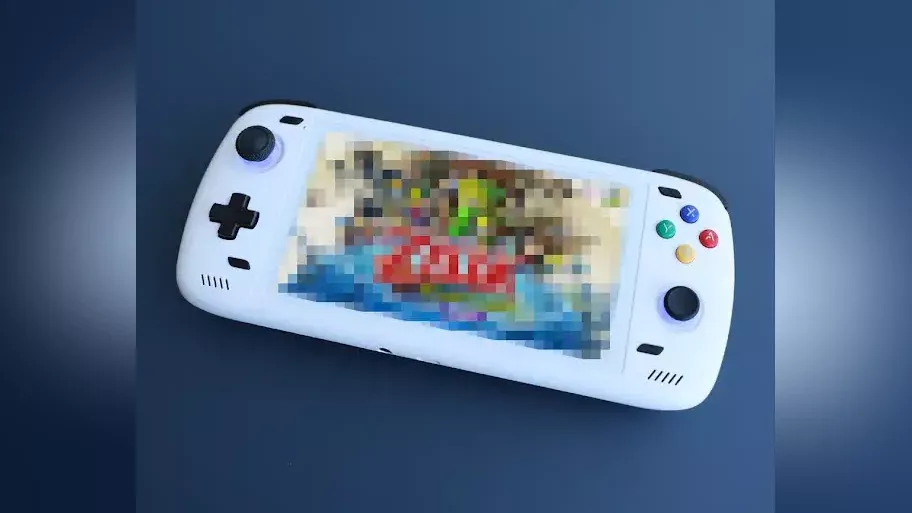 A handheld gaming device with a blurred out image on the main screen.