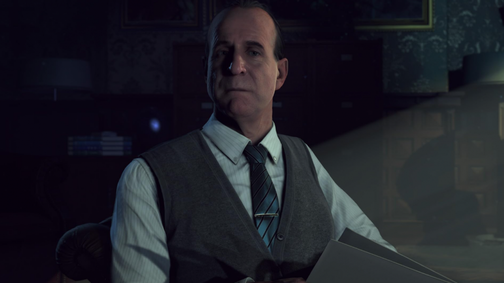 A man in a sweater vest and wearing a blue tie and dress shirt. He looks a bit inquisitive. It's a virtual representation of actor Peter Stormare from Until Dawn.