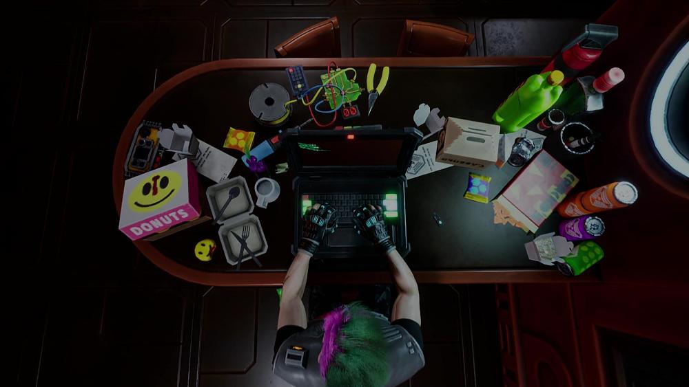 Top-down view of a hacker at her messy desk.