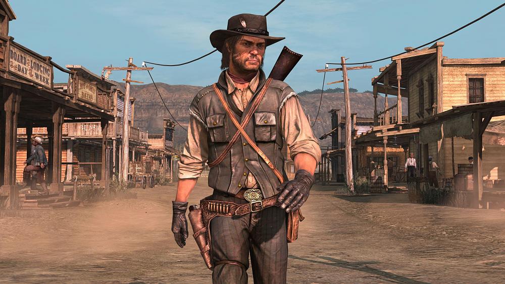 A cowboy in the Old West walking down a dirt road in town.