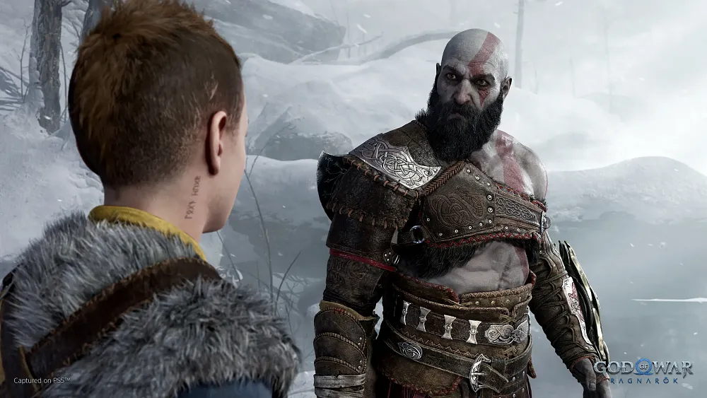 Screenshot of a bald ashen man named Kratos looking angrily towards his son that stands in the foreground