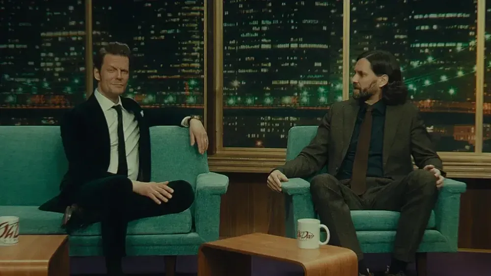 Two men on the set of a talk show.