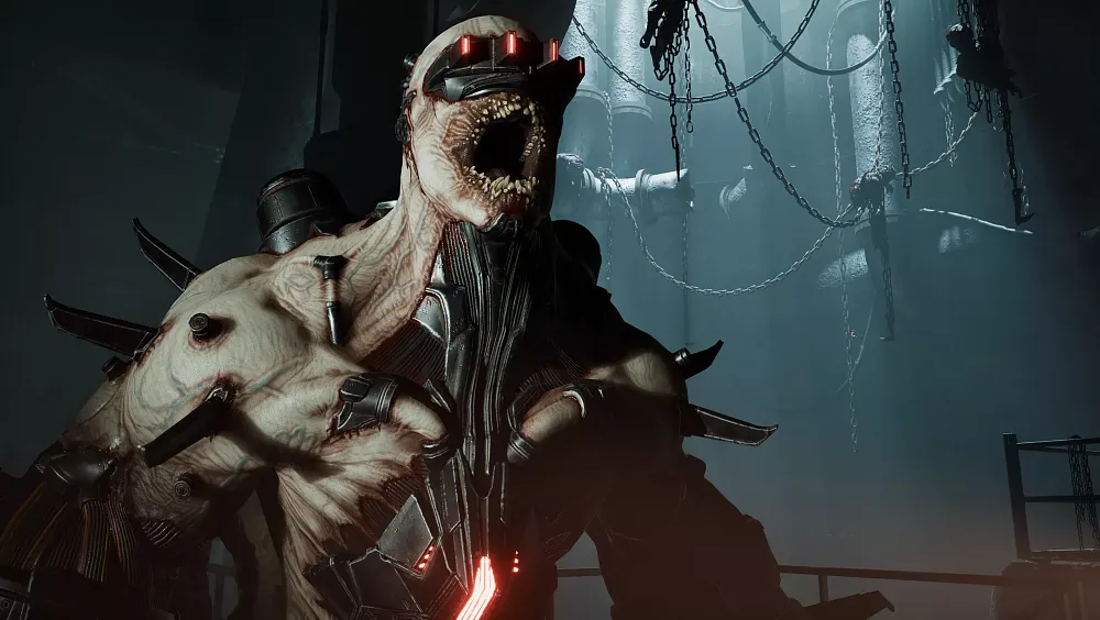 A closeup of a mutated monstrosity from Killing Floor 3 called the Fleshpound. It has several machine parts grated directly onto it covering its eyes and parts of its upper body.