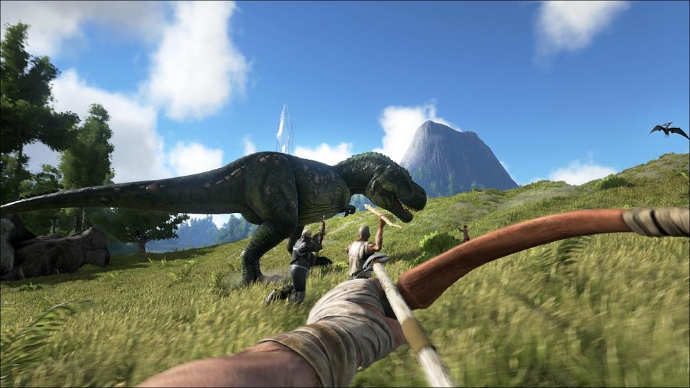 A person aiming a wooden bow and arrow at a T-Rex in an area with rolling green hills. Two other hunters are aiming crude weapons at the dinosaur.