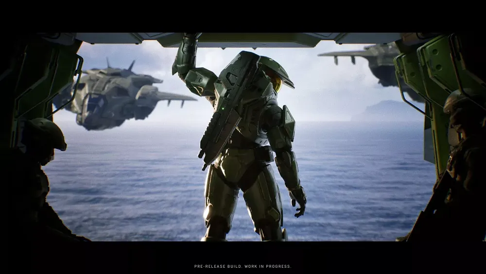 The back view of Master Chief standing inside the back of a flying vehicle.