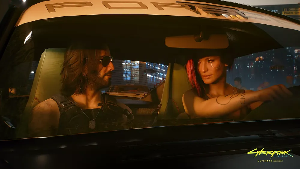 A man and a woman looking at each other inside of a car.