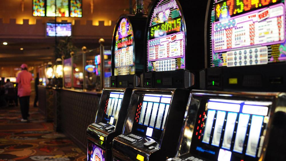 Photograph of three slot machines in a casino.
