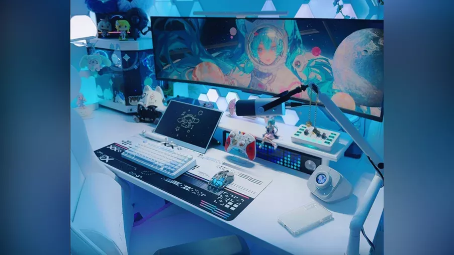 A professional gaming setup featuring a laptop, large monitor, mouse, and several PC accessories.