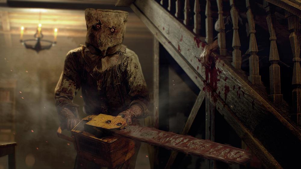 A man with a burlap sack on his head holding a bloody chainsaw.