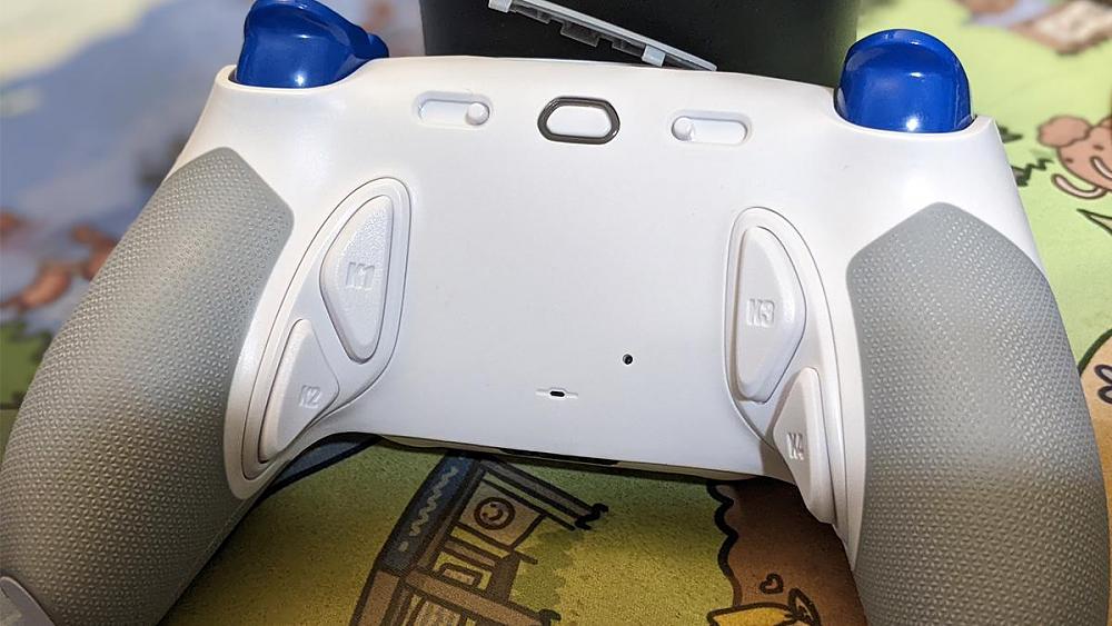 Photo of the back view of HexGaming Phantom showing four remappable back buttons, profile switcher, and trigger adjustments.