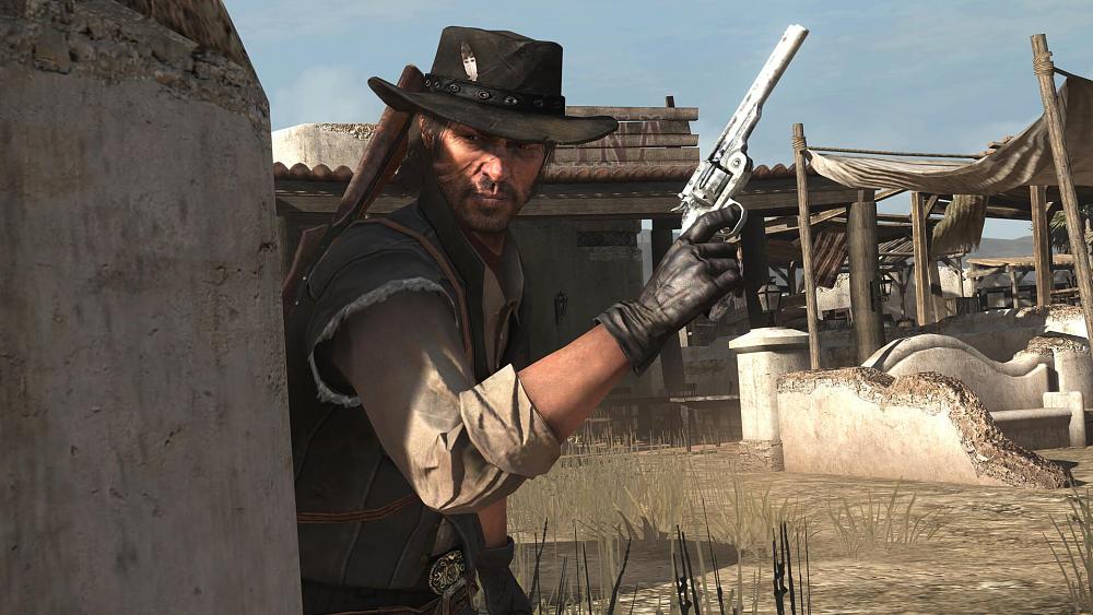 A cowboy holding up a revolver and taking cover behind a wall.