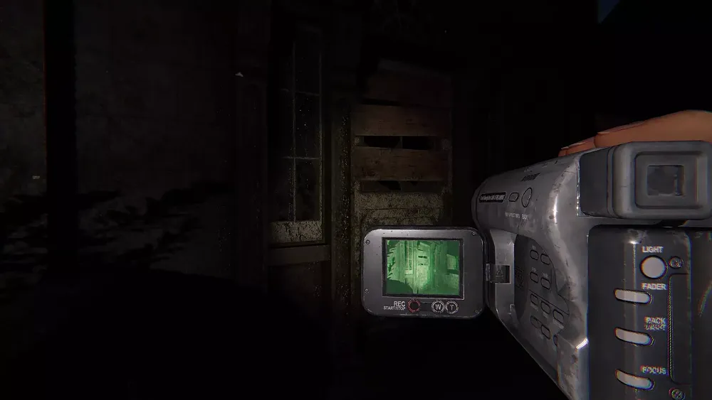 View of a person holding a camcorder searching for ghosts.